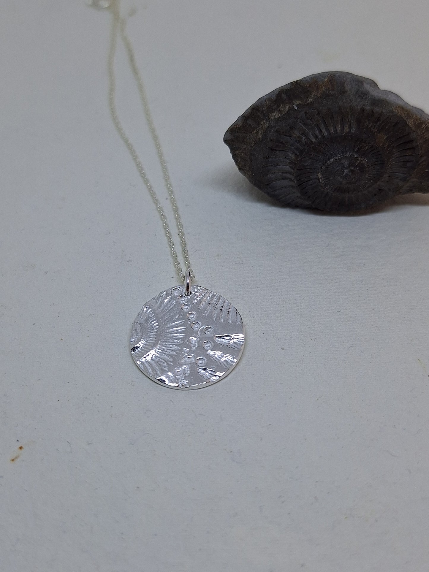 Shell and ammonite pendant