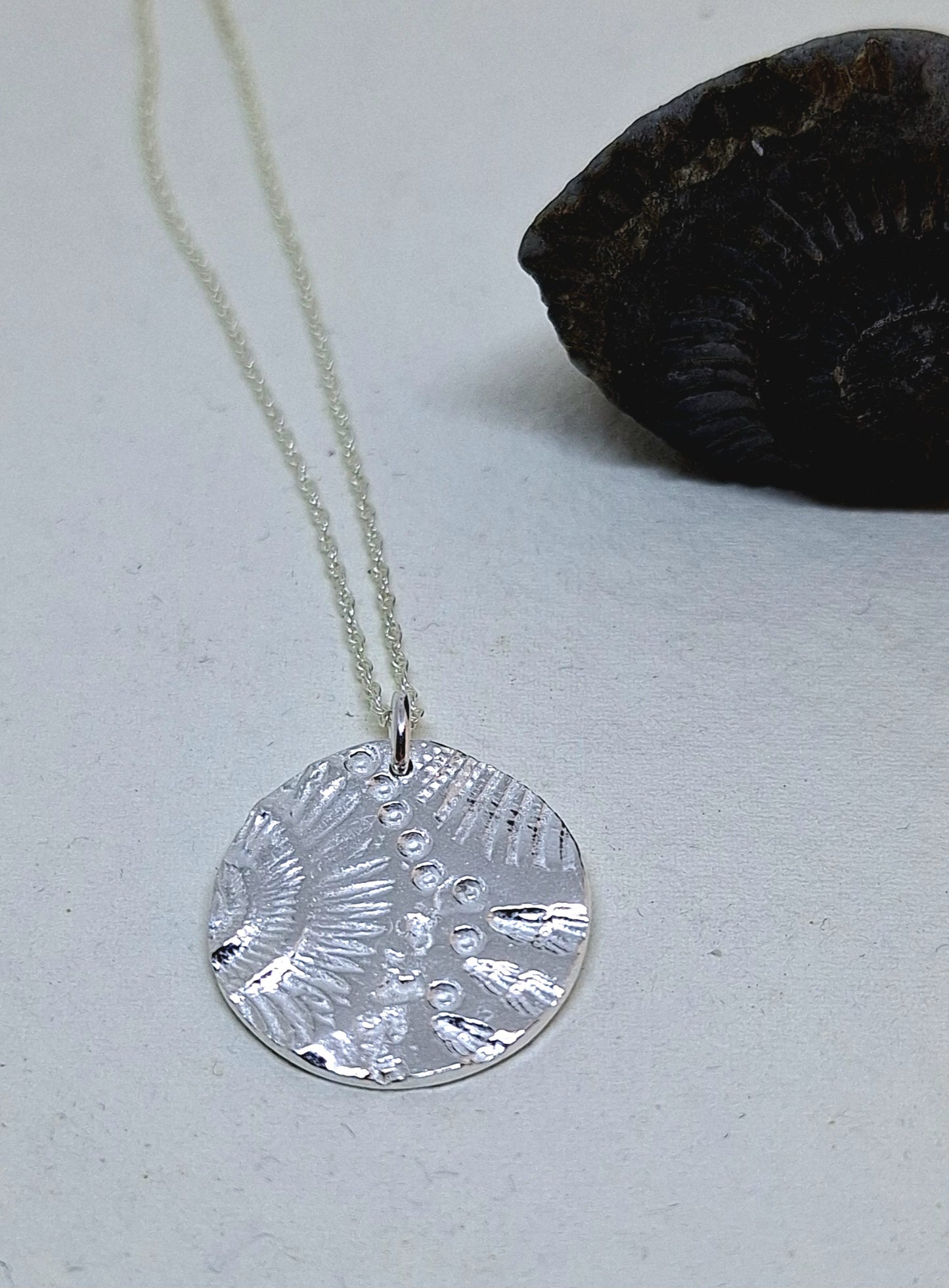 Shell and ammonite pendant